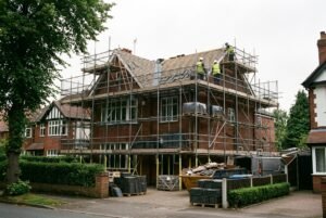 Scaffolding and materials on a Cheshire house during a full roof replacement, highlighting factors that affect the cost.